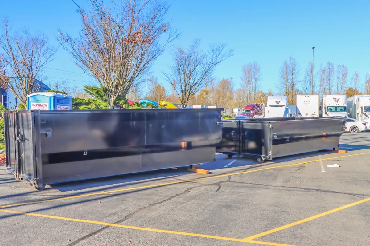 Professional dumpster rental service with roll-off container on residential driveway in Conyers